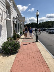 Two ladies strolling on the sidewalk to the Gap